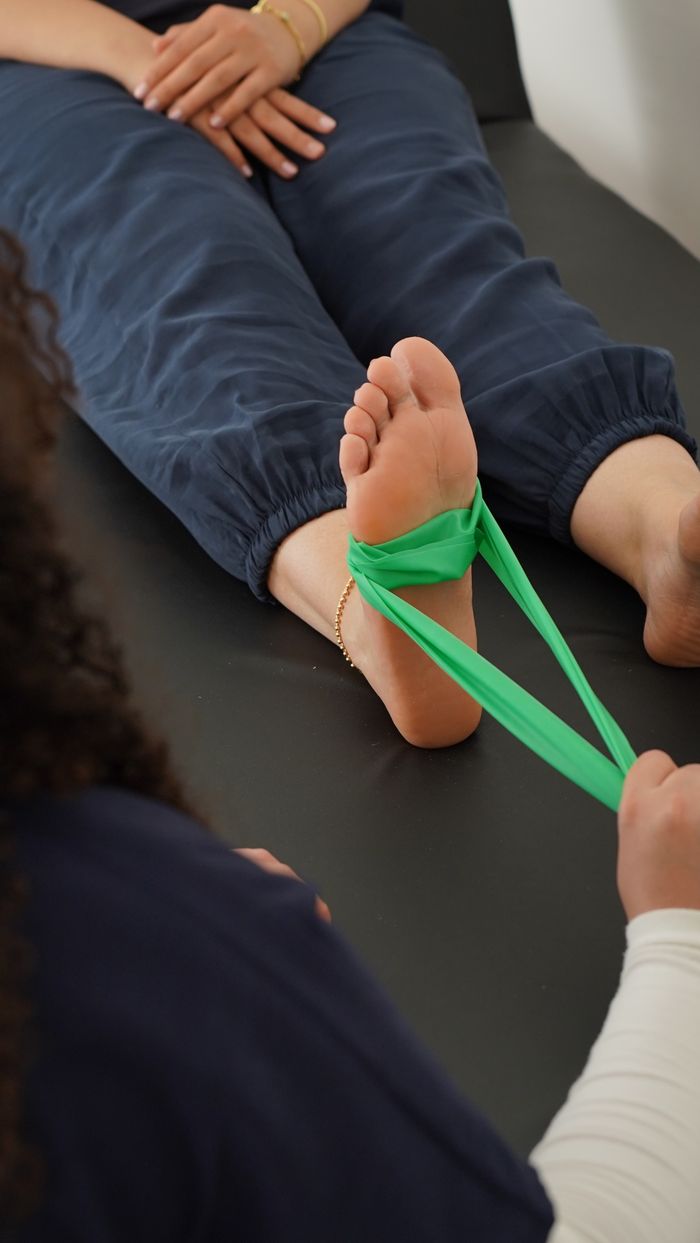 Mastering the First Impression: Your intriguing post title goes here Close-up of a physical therapy session using a resistance band for foot rehabilitation.